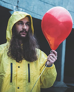 person holding red inflatable balloon thumbnail