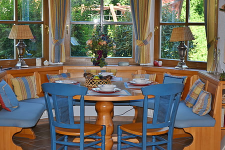 brown wooden dining table with chairs near window thumbnail