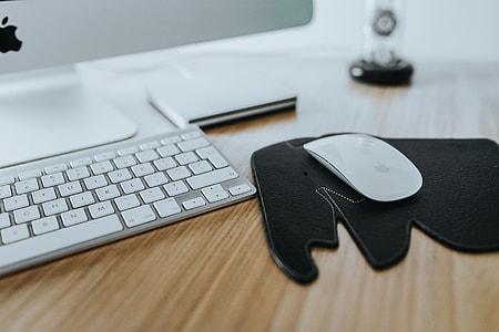 White Apple iMac computer with elephant mousepad thumbnail