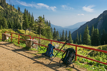 blue and black hiking backpack lying on road thumbnail