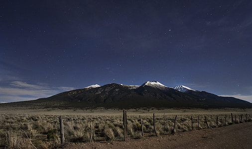 snow capped mountains near dirt road at daytime thumbnail