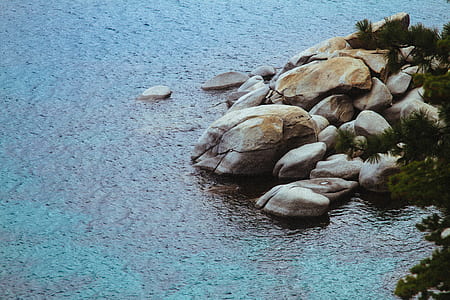 brown rocks near body of water thumbnail