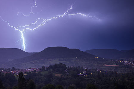 mountain covered with trees under thunder thumbnail