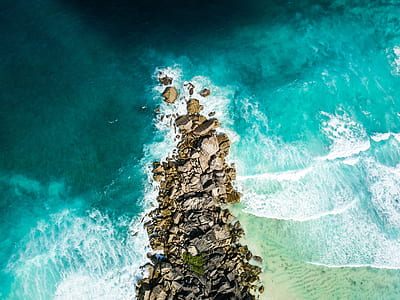 brown stones with body of water photography thumbnail