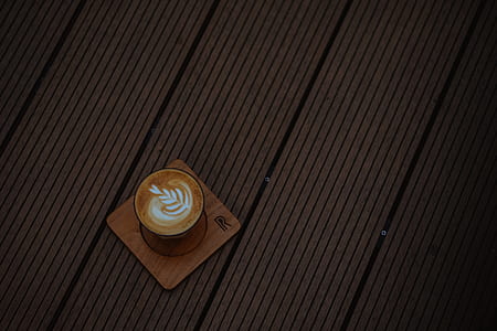 brown ceramic mug on brown coaster thumbnail