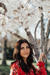 woman clinging on tree branch during daytime thumbnail