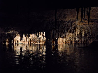 silhouette of stalagmites and stalactites inside a cave thumbnail