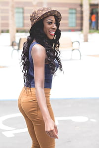 woman in blue sleeveless shirt and brown bottoms thumbnail