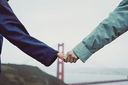 two person holding hands together in front of Golden Gate Bridge during daytime thumbnail