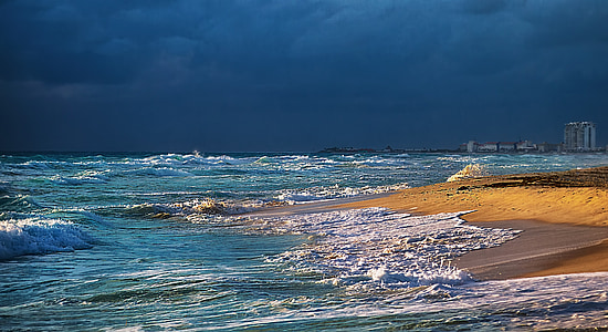 photo of ocean under blue cloudy sky thumbnail