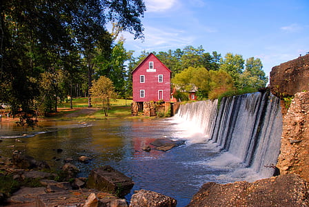 landscape photography of waterfalls and house thumbnail