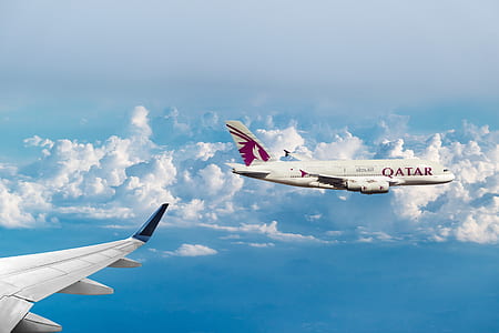 airplane view of white Qatar airplane thumbnail