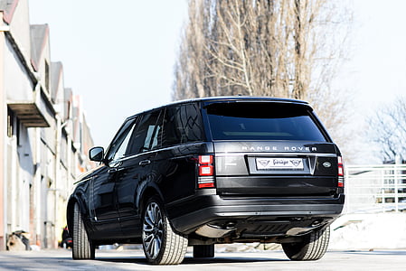 black Land Rover Range Rover SUV making a turn during daytime thumbnail