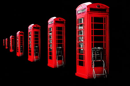 red telephone booth on black surface thumbnail