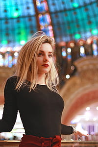 shadow depth of field photography of woman in black scoop-neck long-sleeved shirt inside building thumbnail