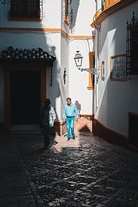 man and woman walking beside the buldings thumbnail