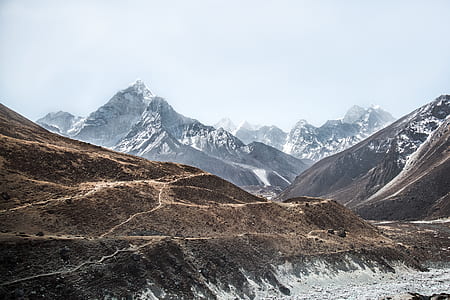 photo of mountains under cloudy sky thumbnail