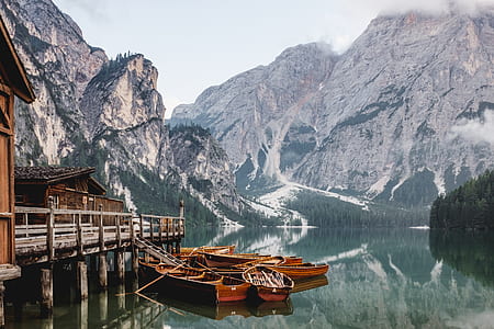 three brown wooden boats on body of water thumbnail