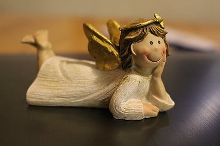 selective focus photography of angel wooden figurine thumbnail