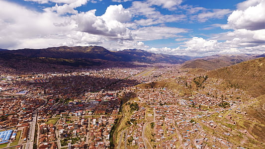 aerial photography of town under white clouds and blue sky during daytime thumbnail