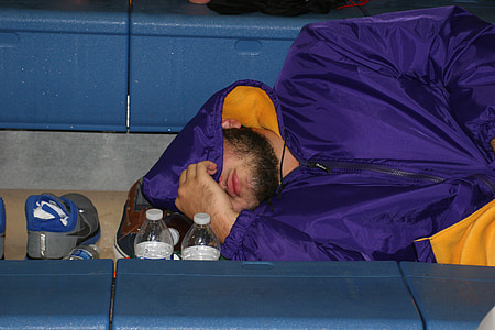 man sleeping on ground wearing windbreaker hoodie thumbnail