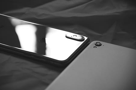 space gray iPhone X beside a black smartphone thumbnail