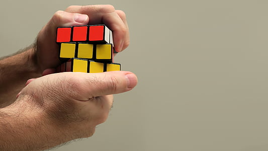 person playing 3 by 3 cube toy thumbnail
