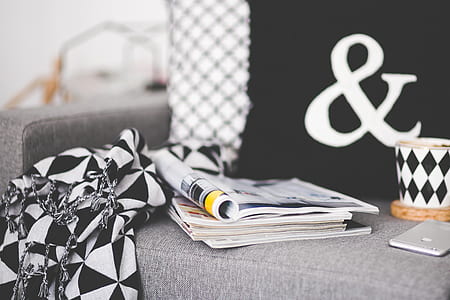 Close of magazines, mug and phone on a couch thumbnail
