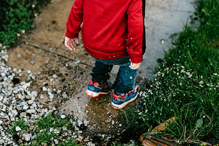 toddler steps on brown concrete pathway beside green grass thumbnail