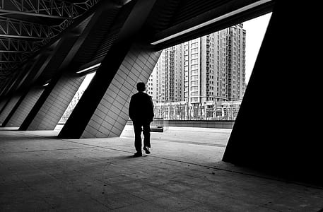 man walking near building at daytime thumbnail