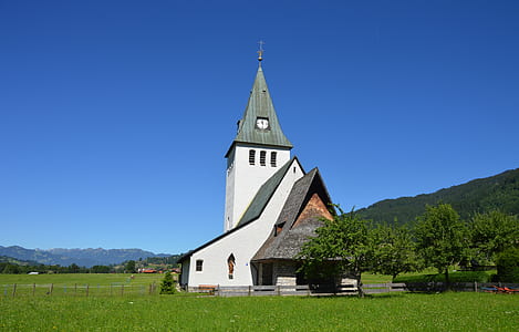 White and Gray Painted Chapel Near Green Open Field during Daytime thumbnail