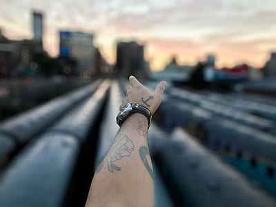 selective focus photography of person's left arm thumbnail