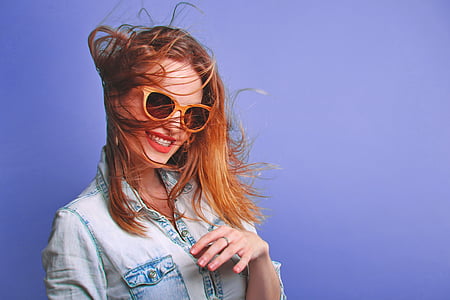 woman wearing sunglasses against purple background thumbnail