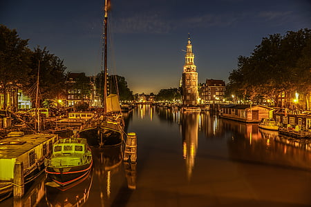 brown concrete tower near river at night thumbnail