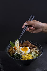 person holding chopstick while eating thumbnail