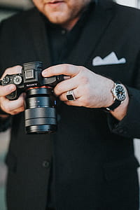 person using black Sony DSLR camera thumbnail