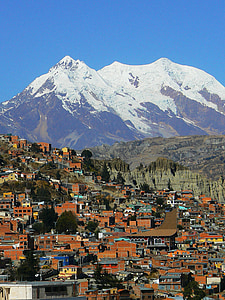 city near the snow capped mountain thumbnail