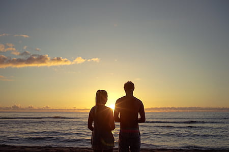 silhouette couple in front of beach thumbnail
