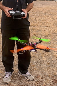 person controlling black quadcopter drone thumbnail