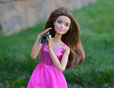 close-up photo of Barbie doll holding camera thumbnail
