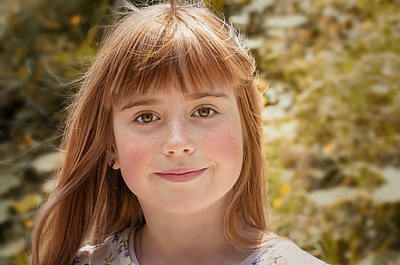 focus photography of girl in floral shirt thumbnail