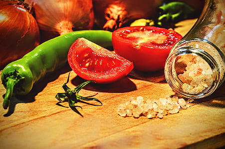 sliced tomatoes and green chili on wooden table thumbnail