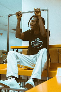 man sitting on desk holding steel bar thumbnail