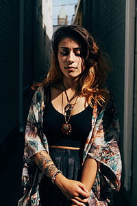 woman wearing black crop top and black bottoms with floral kimono thumbnail