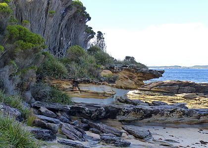 rock formation near body of water thumbnail