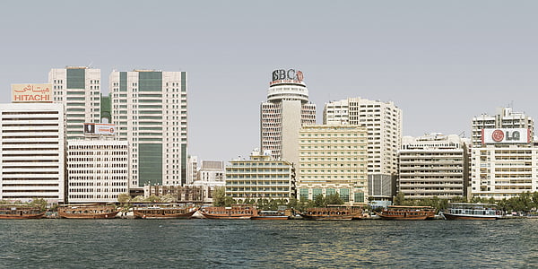 selective focus photo of HSBC building near body of water under gray clouds thumbnail