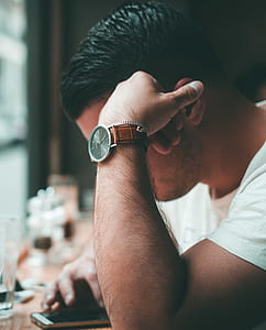 man in white top resting his left arm thumbnail