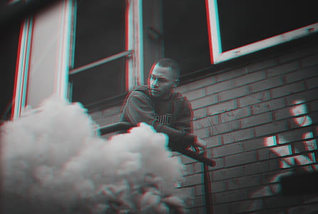 man leaning on black metal railings thumbnail