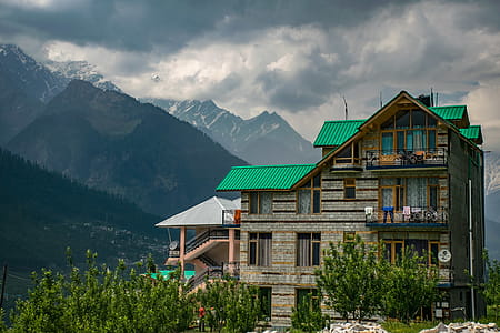 Brown and Green Concrete Building Near Mountains at Daytime thumbnail
