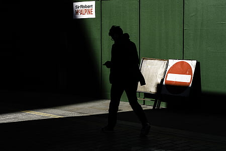 person's silhouette walking on side of street thumbnail